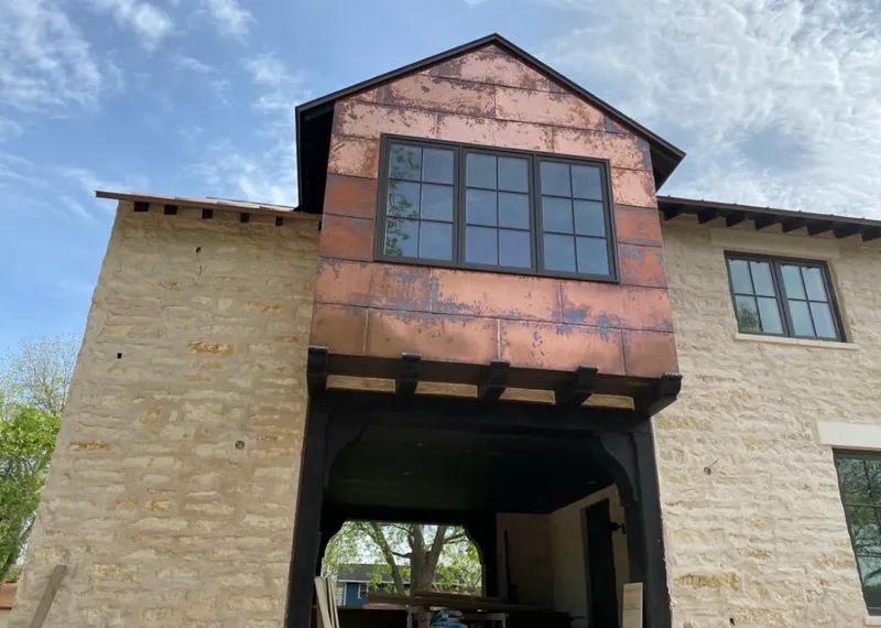 Copper metal panel facade on a stone building for Skylight Installation in South El Monte